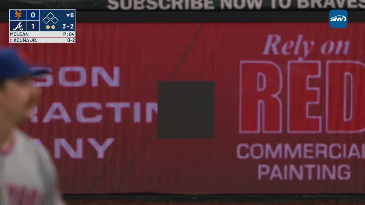 One of Nolan McLean's warmup pitches knocked out a panel in the electronic signage behind home plate at Truist Park