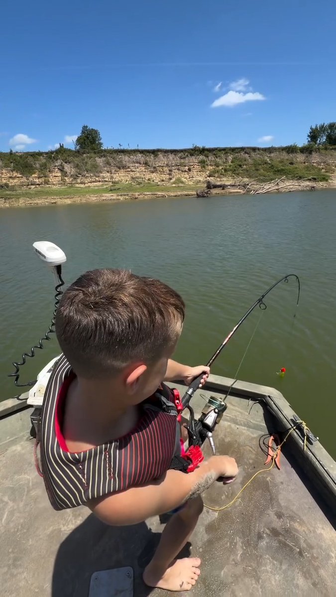 Little dude goes fishing with his dad, hooks an absolute monster, and has the fight of his life trying to reel it in