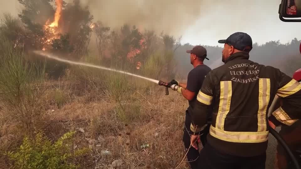 Residents joined firefighters and air units to battle wildfires in southeastern Montenegro, as strong winds complicated efforts to contain the blaze