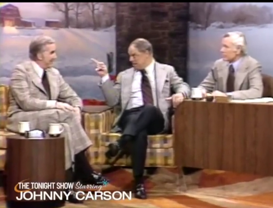 With Don Rickles the real gold hits when the physical comedy takes over. The exaggerated leans, the mock despair, the way he swings his whole torso toward Johnny or Ed the second a punchline lands. That wide-eyed “are you serious?” look… the sudden grimace then the little satisfied smirk after a particularly brutal line aimed at Johnny. Whenever Carson tries to steer things or ask a straight question, Rickles answers with that perfect deadpan to explosive shift. Ed just sits there taking the hits while Rickles turns the entire couch into his personal stage. And somehow under all the abuse the affection is still there, those quick glances back at Johnny like the two of them are in on the same joke.