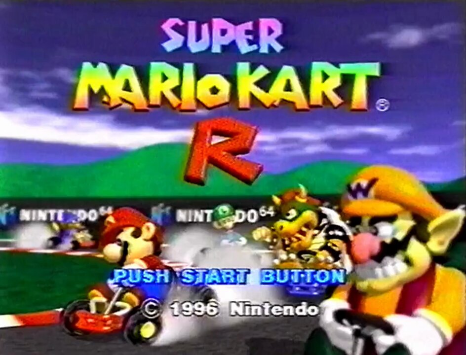 Part of Nintendo's E3 1996 B-Roll (recently digitized by VGHF) includes early footage of Mario Kart 64, then known as Super Mario Kart R! In this clip you'll find a different title screen, different character icons, and Kamek the Magikoopa as a playable racer.
