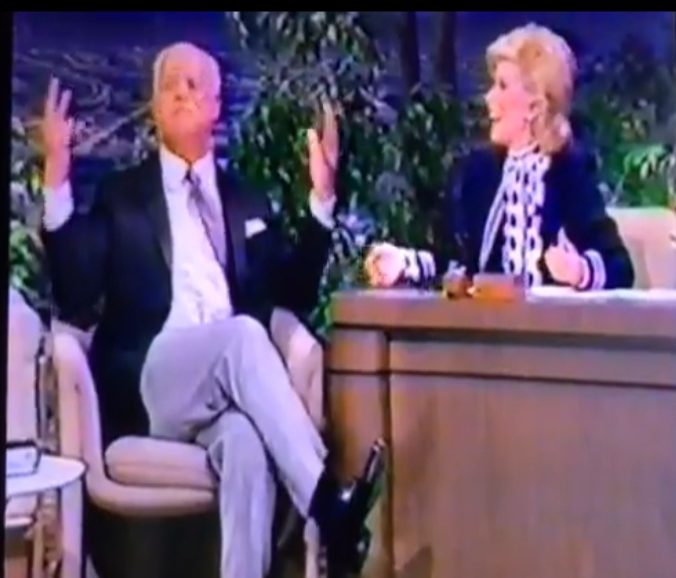 Don Rickles sitting across from Joan Rivers while she’s hosting The Tonight Show is dangerous. He doesn’t ease in. He starts roasting her outfit, her marriage, her workaholic habits, and her whole life within the first minute. Joan is one of the few people who can actually keep up with him, and even she spends half the time just trying not to fall out of the chair laughing. Two of the fastest, meanest, most affectionate comics of all time going head to head with zero safety net. If this isn't what peak chemistry looks like.