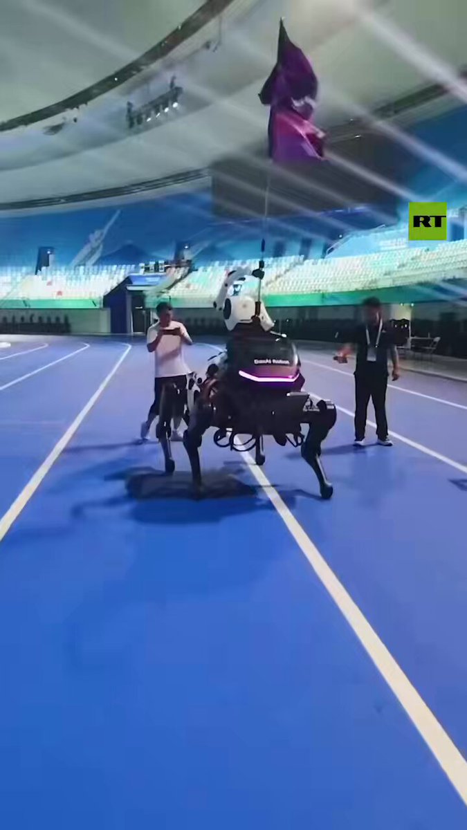 REHEARSAL for opening night of World Humanoid Robot Games in China HUMANOID-BOT straddles QUADRUPED robot