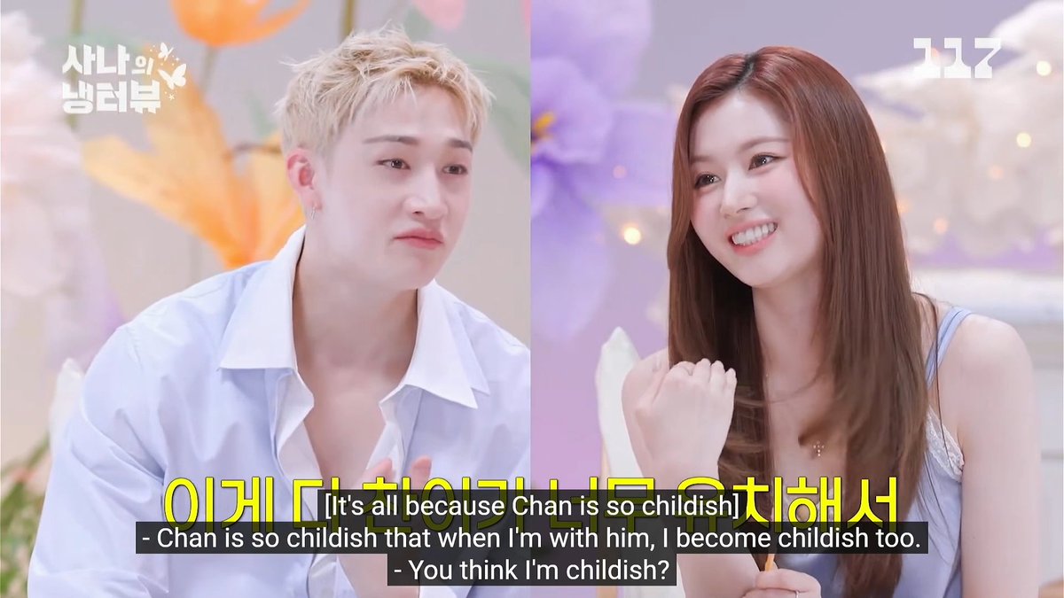 Sana and Bang Chan bickering, saying that Sana was chubby & Chan was lanky back then 😭 SN: Chan is so childish that I become childish too BC: No it's because you're childish, I'm just matching you BC: First impression? She was chubby back then! SN: You were all lanky & small!