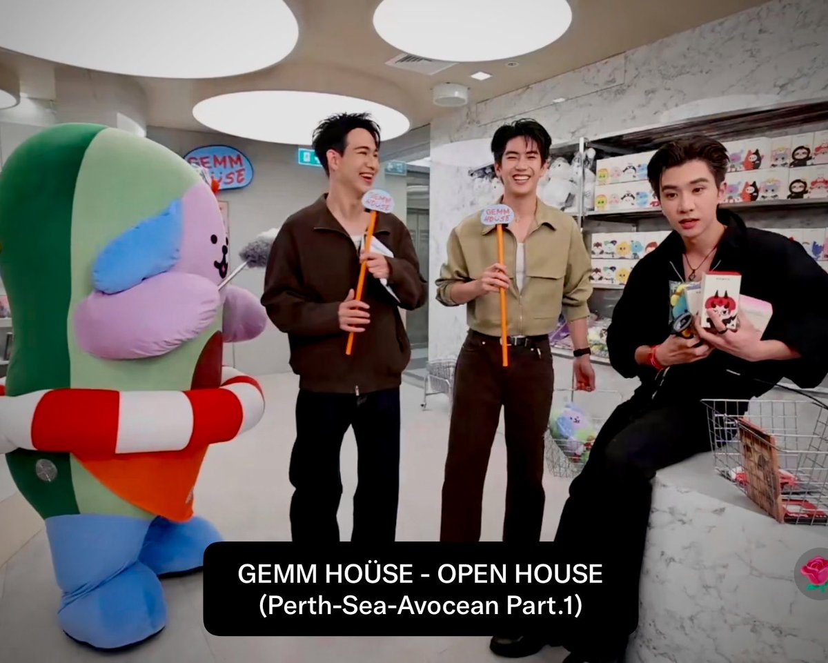[ENG Trans] — GEMM HOÜSE 🍵 OPEN HOUSE #GEMMHOUSEopenhouse #PerthTanapon #sea_tawinan #avocean — 🔴 LIVE GEMM HOÜSE WITH PERTH & SEA WITH AVOCEAN (Part.1) 🎤 Host: Hello, and welcome, Perth, Sea, and Avocean! 🩵 Sea: Hello! 🖤 Perth: Hello! 🎤 Host: Avocean, you’ve been working very hard. What are you doing right now? 🥑 Avocean: I’m cleaning. 🎤 Host: Oh, he’s taken on the responsibility of cleaning. 🩵 Sea: Yes, he’s cleaning right now. 🖤 Perth: (asks Sea) Are you a single papa today? 🩵 Sea: Yes. Today, I’m playing the role of a single papa. 🥺 🖤 Perth: Aww, aww. ⸻ 🎤 Host: Where are we right now, Perth? 🖤 Perth: Right now, we’re at the sales point for our new merchandise. It’s for our own house. 🩵 Sea: Yes, “GEMM HOÜSE”. 🖤 Perth: That’s right. From now on, you can come and shop for the merchandise on the second floor. There are so many things available. 🩵 Sea: Perth, are there any products you would recommend to the fans? 🖤 Perth: Actually, I’ve picked up so many things. Our house has a huge variety of products, including Avocean and Domiia. ⸻ 🥑 Avocean: (dusts Leo off) 🎤 Host: Wait a second… Avocean, this uncle isn’t that dirty! Why are you dusting him off? Has dust already started gathering on him? (joking) 🖤 Perth: I’m taking everything. I’m buying it all. 🎤 Host: Everything from Domiia? 🖤 Perth: Domiia too, and Permpoon as well. 🩵 Sea: Oh, there’s a Domiia glass too. 🖤 Perth: Look Khunnoo. 🩵 Sea: Wow, Look Khunnoo! 🖤 Perth: This, this, this one definitely… (picks up a Gemini–Fourth postcard) 🩵 Sea: What is it? 🖤 Perth: These two are dating. (Gemini–Fourth) 🩵 Sea: Really? 🖤 Perth: They have feelings for each other. Just look at the way they’re lying down. (on the postcard) Who normally lies like this with someone else? Look! This shows that they really, really have feelings for each other. 🩵 Sea: Aaaahhh! Hahaha! 🖤 Perth: They’re really a couple. 🩵 Sea: You two can sort it out backstage yourselves. I have nothing to do with this. 🎤 Host: You’re saying Gemini and Fourth are a couple? 🖤 Perth: Yes. 🎤 Host: Yesterday, you just made a statement at the concert that between “Pond and Phuwin”— 🖤 Perth: They’re a couple too. 🎤 Host: And what about “Perth and Santa”? 🖤 Perth: As for “Perth and Santa,” we’re pak kat. (joking) Hahaha! ⸻ 🎤 Host: So, what do you think of this new place? This is our new GMMTV SHOP. Normally, fans would have to go all the way up to the 30th floor, but now, as soon as you come into GEMM HOÜSE, you’ll find this huge, open area where you can freely browse and choose all kinds of merchandise. 🖤 Perth: (uses the barcode scanner on Sea, scanning him) 🎤 Host: Oh! What are you doing? Did you manage to scan him? What status does it show? Does he already have an owner? 🖤 Perth: Beep, beep, beep… It says there’s a P’Jimmy inside him. (joking) 🩵 Sea: Hahaha! 🥰 🖤 Perth: (hugs Sea to apologize for teasing) (Cont.)