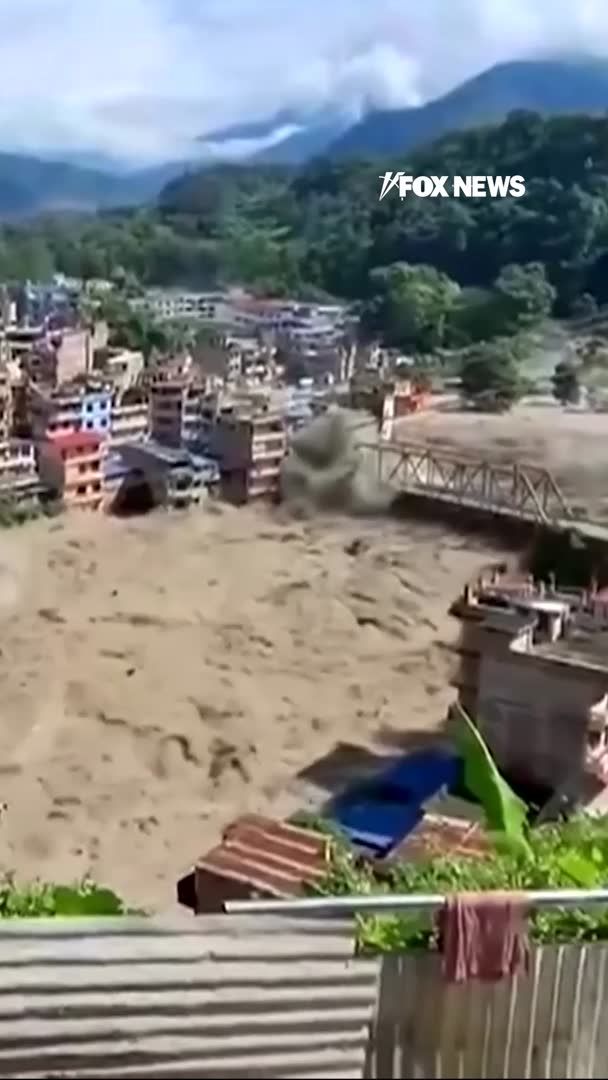 Dramatic video captures raging floodwaters tearing through Nepal, sweeping away a bridge as deadly flash floods devastate communities along the Nepal-China border. At least 160 people have been killed, while hundreds remain missing. Nepalese officials say 403 people are unaccounted for, including 341 foreign nationals, as rescue efforts continue across the disaster zone. Experts say a glacier avalanche was the likely trigger for the catastrophic flooding.