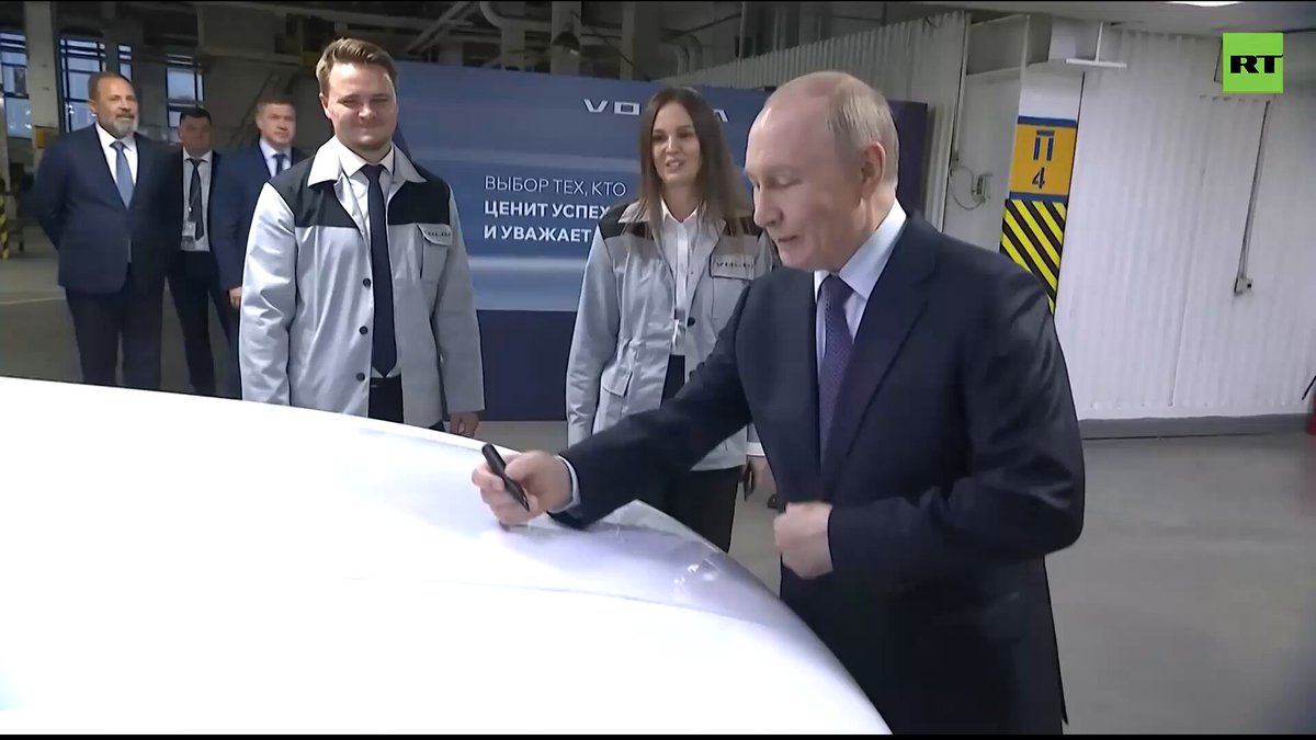Putin takes the new Volga car out for a ride Gives it his personal signature as a bonus