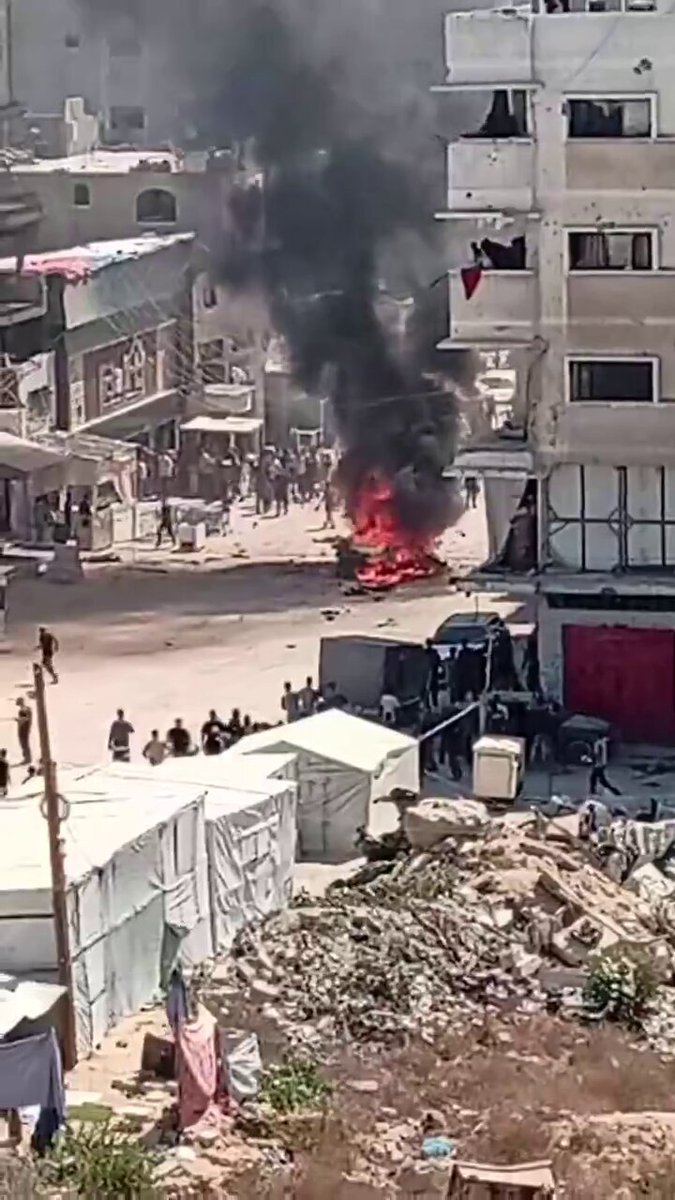 West of Gaza City, an Israeli strike engulfed a civilian vehicle in flames with people trapped inside.
