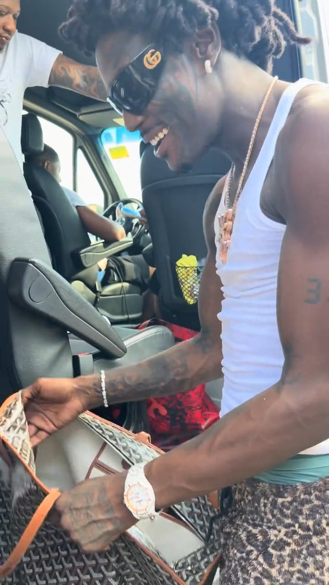 Tezzus shares a close look at what he carries in his bag for the YSL Next Generation Tour 👀🐍 Sunglasses, cologne, gloves for “Fck ngas”, 🍃, journal, belt, deodorant, chapstick, earphones 😭