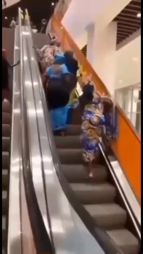 Women stir reactions online as they struggle to ascend an escalator at a mall