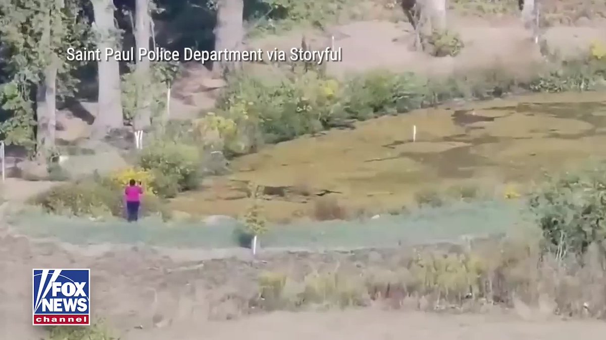 A Minnesota police officer wades into a pond and carries an autistic child safely to shore after a drone helps authorities locate the child within minutes. Saint Paul police say the child had wandered away from home without the family's knowledge and appeared to be struggling in the water. A public safety drone arrived two minutes before officers, providing the child's location and status so responders could quickly reach them.