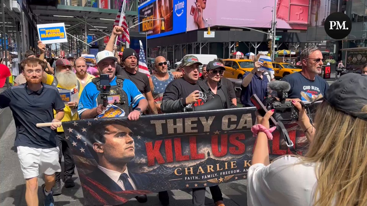 J6er and activist Jake Lang marches through Times Square with a Charlie Kirk banner that reads “They Can’t Kill Us All." Footage by NJEG Media