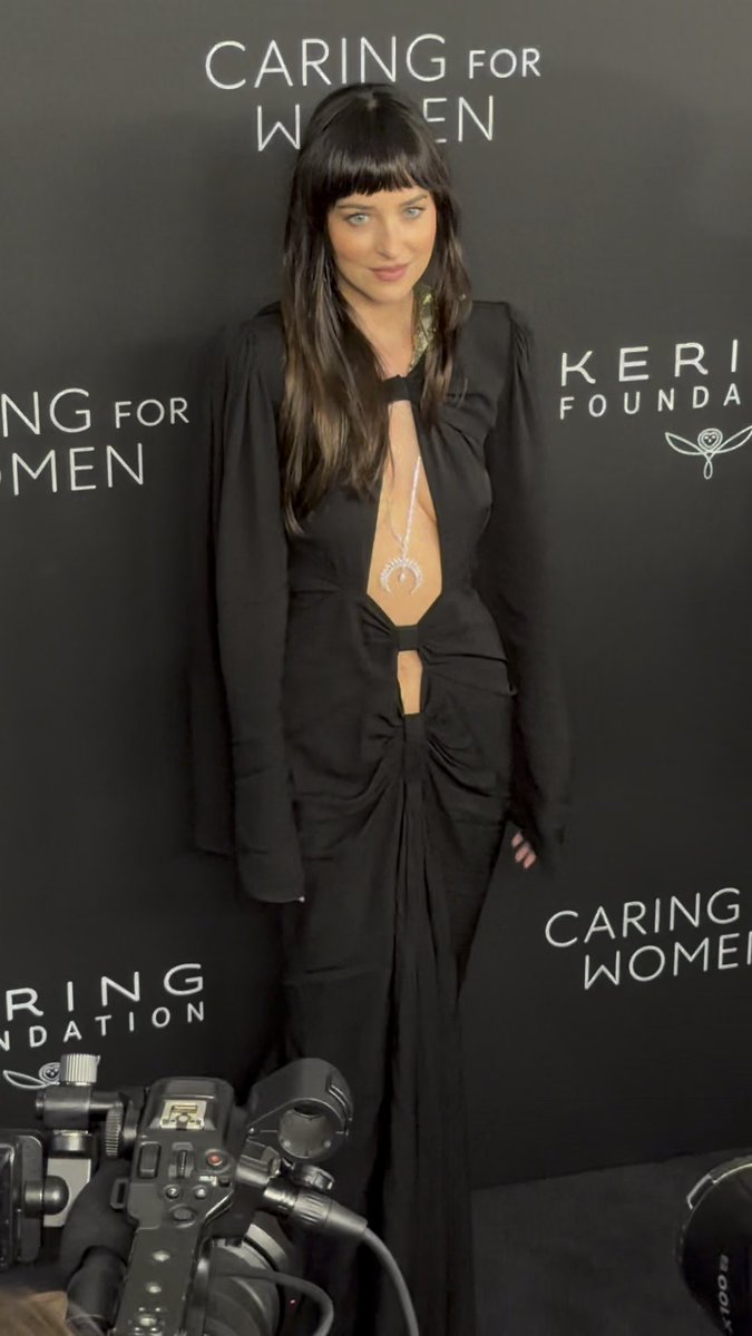 Dakota Johnson bares a little bit of skin in a cut-out dress at the Kering Foundation's Fifth Annual Caring For Women Dinner during NYFW. #DakotaJohnson Video: @JPASC24