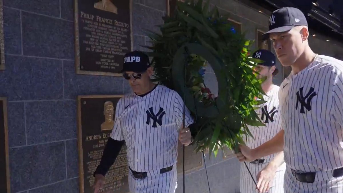 Aaron Judge, Gerrit Cole, and Aaron Boone place a wreath beside the 9/11 tribute in Monument Park, which was dedicated at the original Yankee Stadium on the first anniversary of the attacks in 2002.