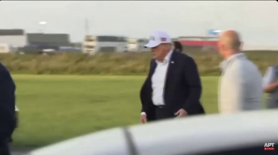 Trump leaving the Irish Open accompanied by Natalie Harp.