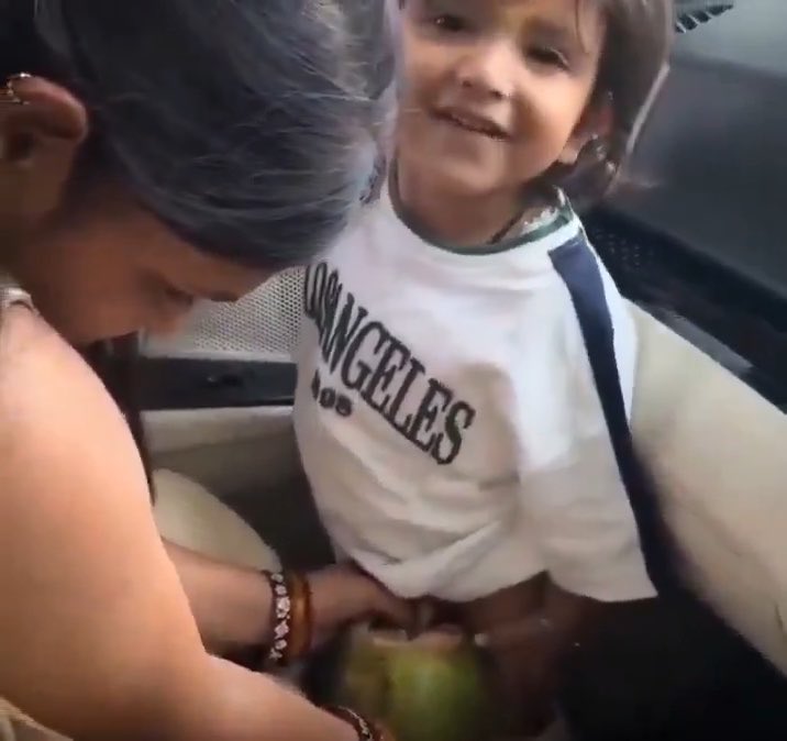 Mother used a coconut shell to let her child pee and threw it out of a moving vehicle . Is this clever parenting or irresponsible behavior?