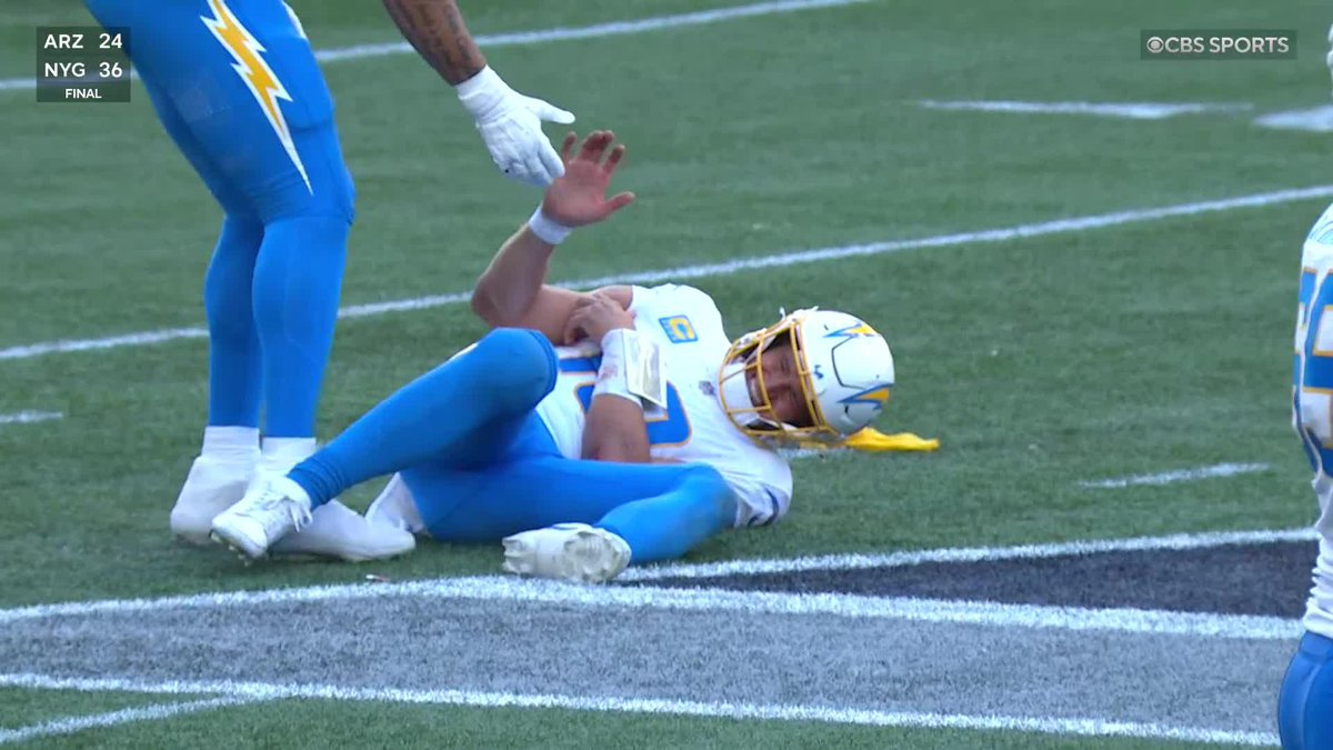 Justin Herbert is down in some pain after taking this hit