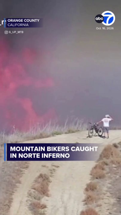 Dramatic video captured by mountain bikers shows the Norte Fire in Orange County rapidly intensifying as strong Santa Ana winds drove flames across the popular Las Ramblas Trail.