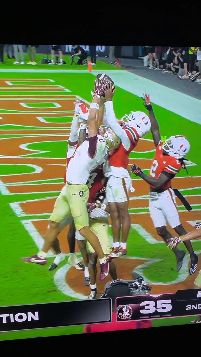 1. it wasn’t a hold on the first FSU TD 2. FSU player has 2 hands on ball while down but ball is in lap of Miami player, who doesn’t actually appear to have both hands on the ball simultaneous possession?