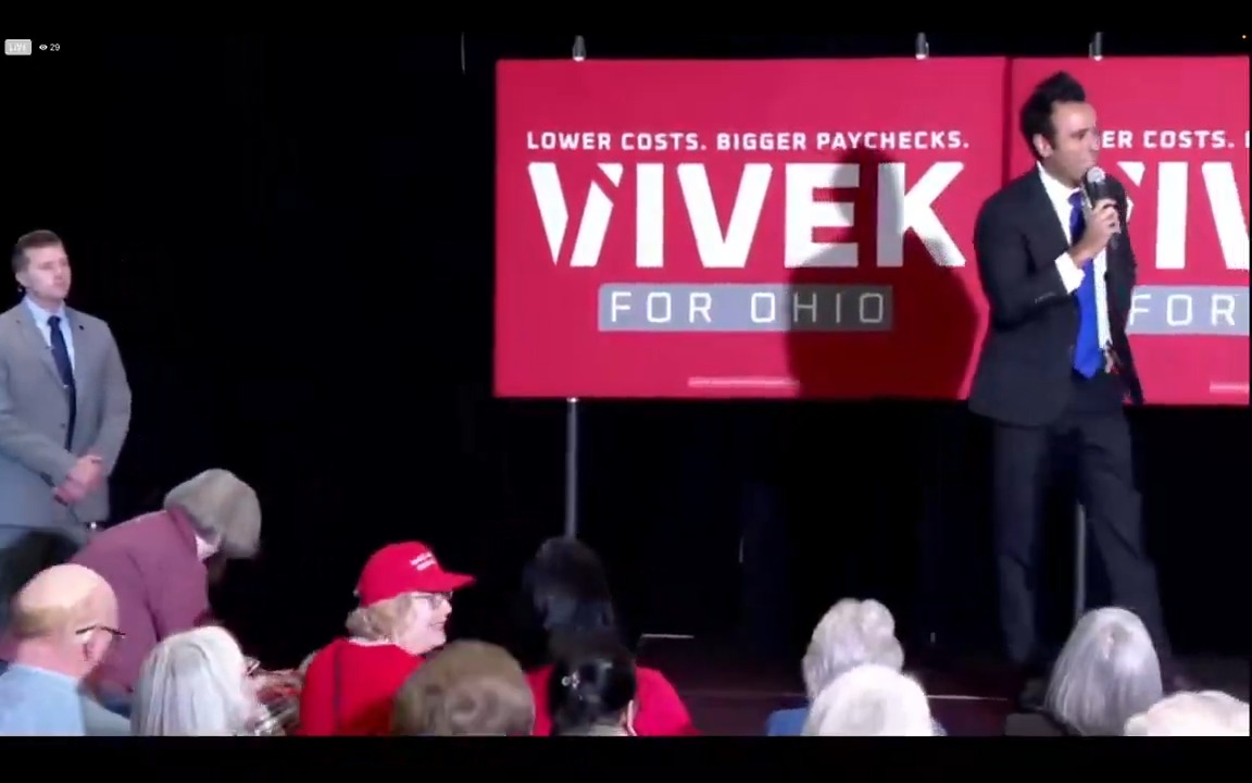 Mere seconds after Ramaswamy takes the stage in Columbus, an attendee begins yelling at him for his ad with Amy Acton's mother about childhood abuse