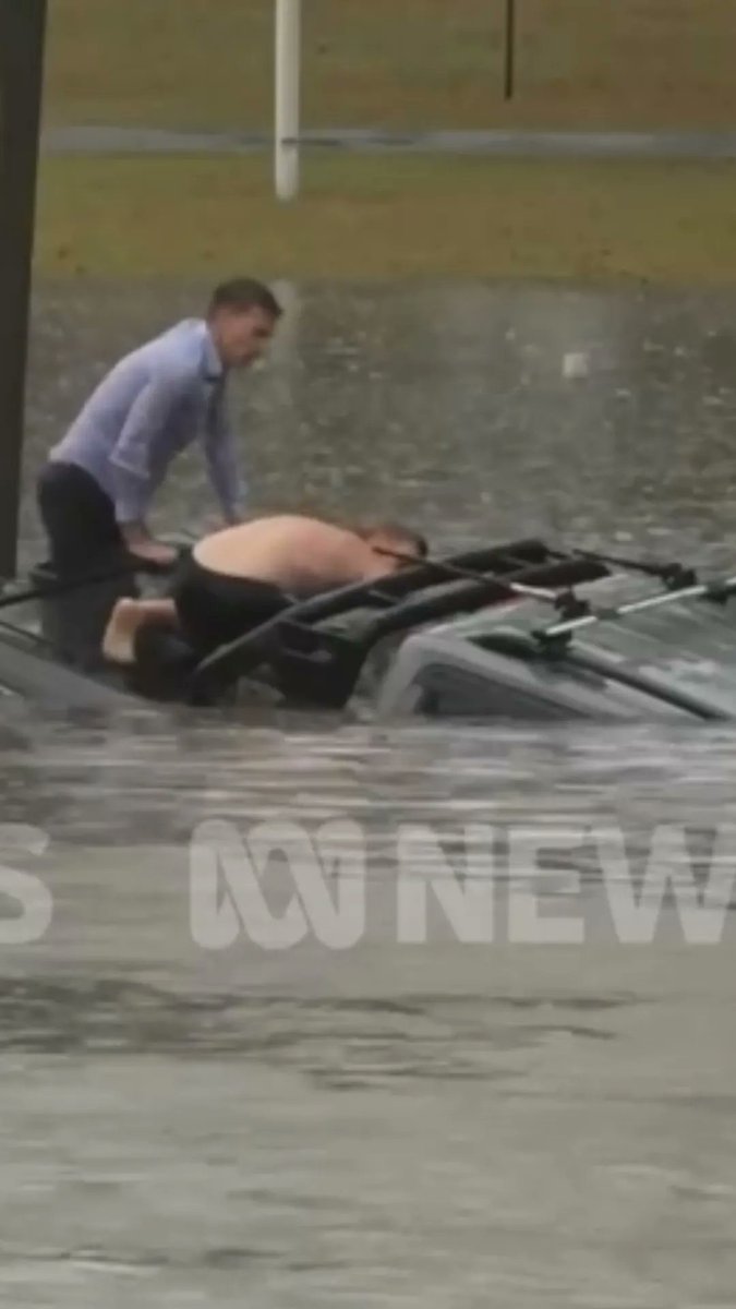 Two bystanders, including a television reporter, rescued a driver from a sinking car trapped in floodwaters in Morayfield, Australia, on Thursday. Australian Broadcasting Corporation reporter Will Murray and another man jumped into the water and swam towards the vehicle to help the trapped driver.