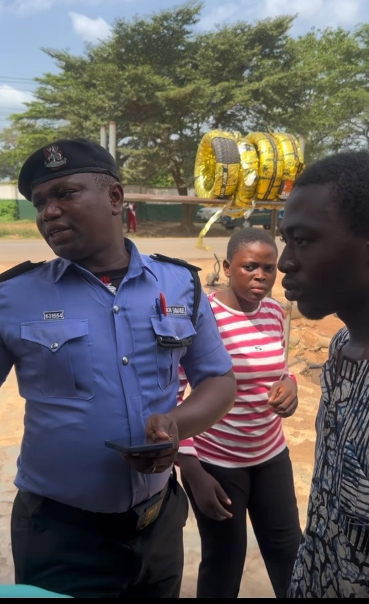 Drama As a Man Brings a Police Officer To Arrest a Vulcanizer After His Car Gets a Flat Tyre In Front Of Their Shop. He Accuses The Vulcanizers Of Deliberately Dropping Nails On The Road To Give Motorists Flat Tyres And Force Them To Patronise Their Shop. Things Take a Different Turn When Bystanders Demand That The Officer Produce An Arrest Warrant, But He Insists That His Uniform Gives Him The Authority To Act Without One. 👀