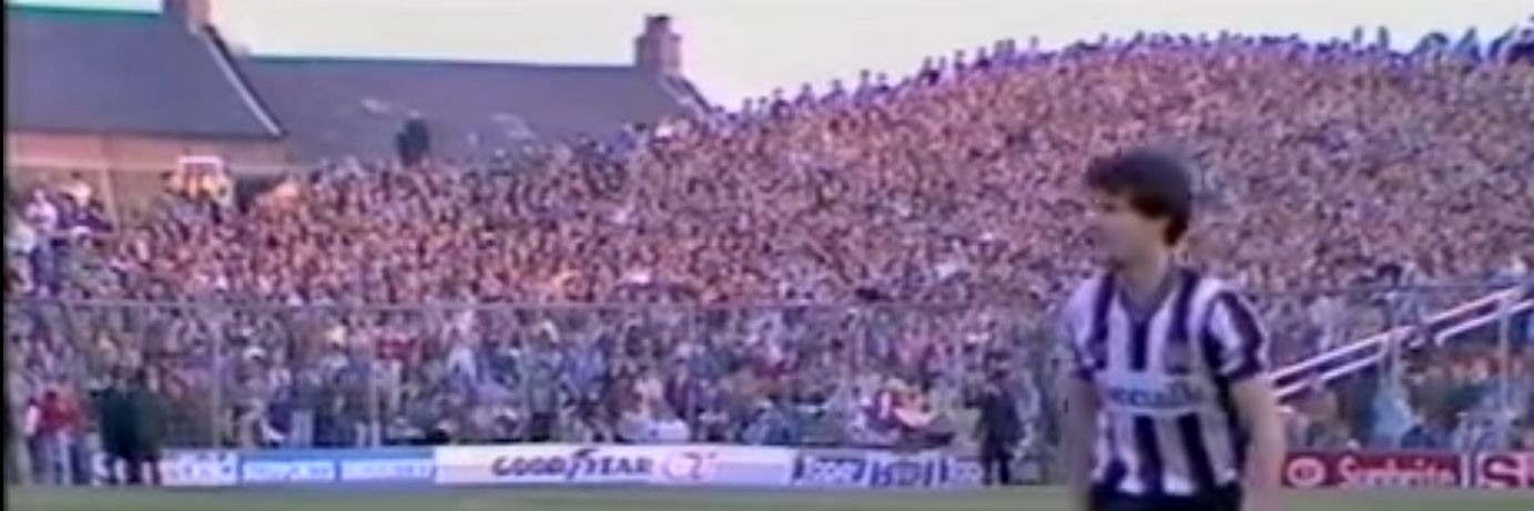 Kenny Wharton sits on the ball's banner